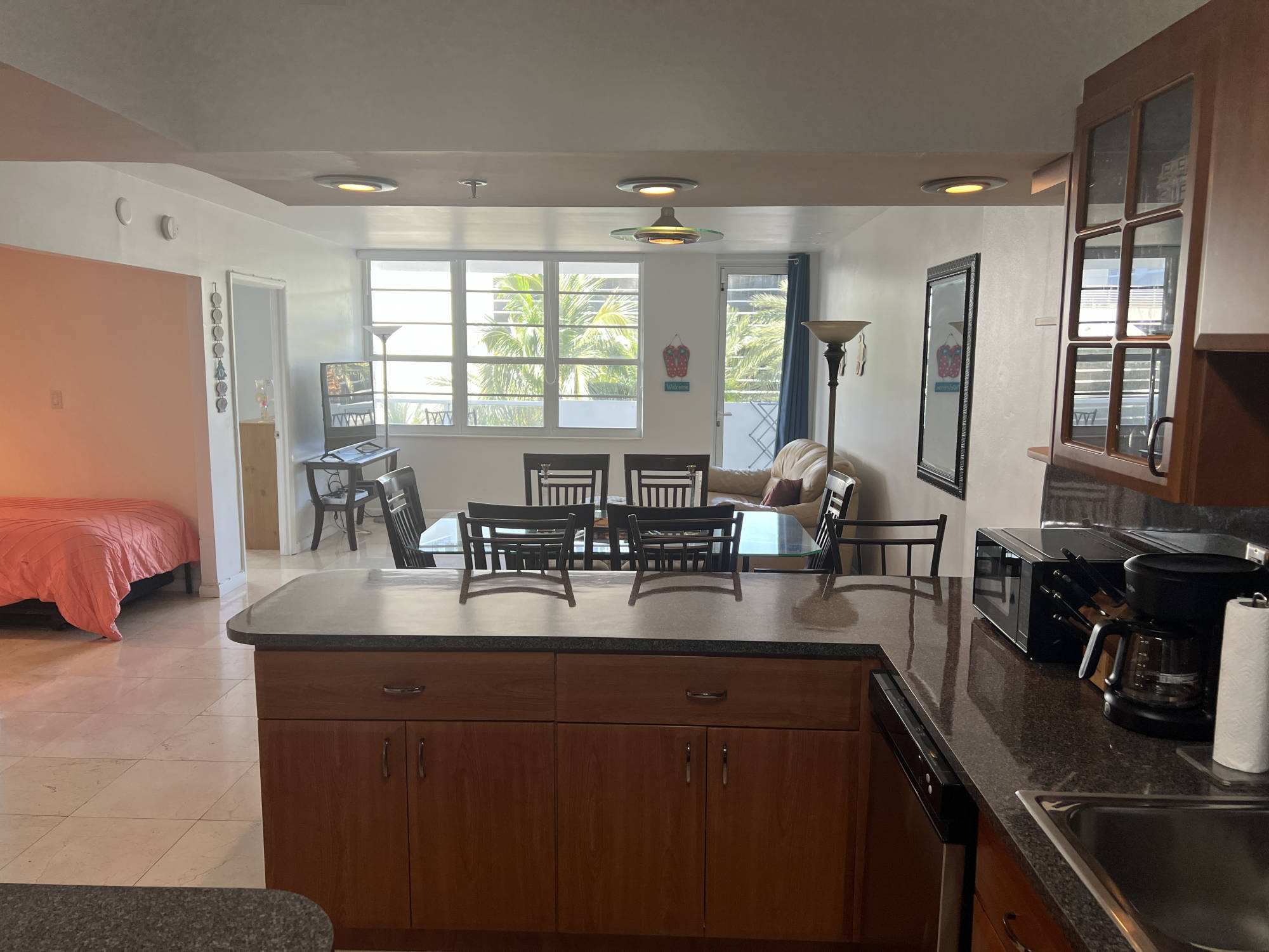 living room seen from kitchen with balcony in background